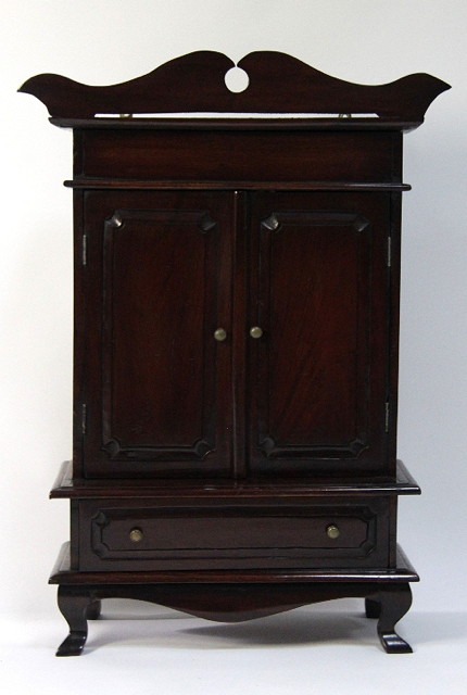 A miniature cabinet with shaped