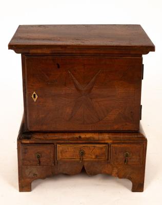 A miniature walnut cabinet on