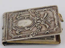 A miniature white metal pendant