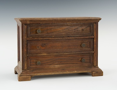 A Miniature Wooden Chest of Drawers