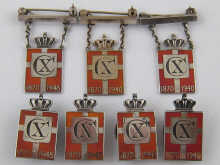 A mixed lot comprising three badges