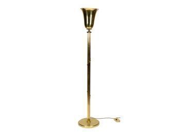 A modern brass floor lamp, with a