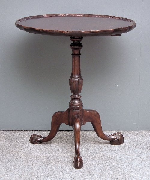 A modern circular tripod table of