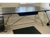 A modern desk, with a black le