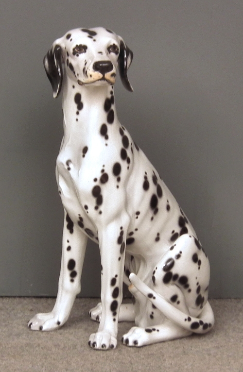 A modern pottery figure of a seated