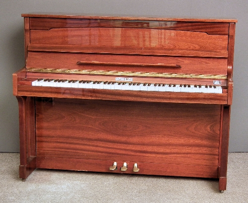 A modern Ritmuller upright piano in