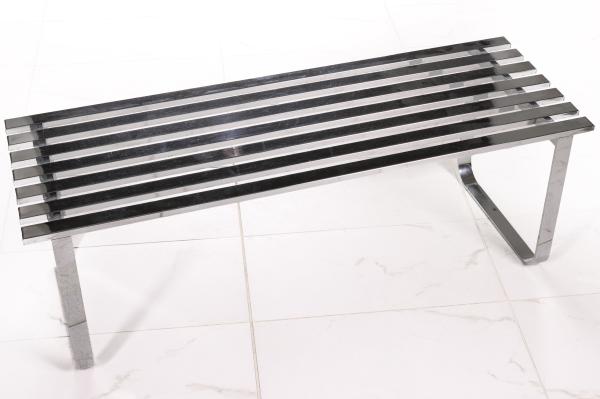A MODERN SLATTED BENCH IN THE