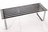 A MODERN SLATTED BENCH IN THE