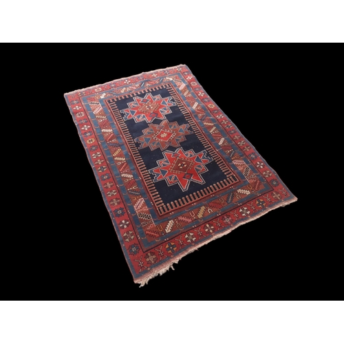 A MOGHAN KAZAK POLYCHROME RUG. LATE