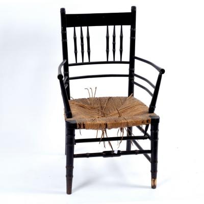 A Morris & Co. ebonised armchair