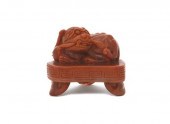 A Nanhong Agate Carved Lion th