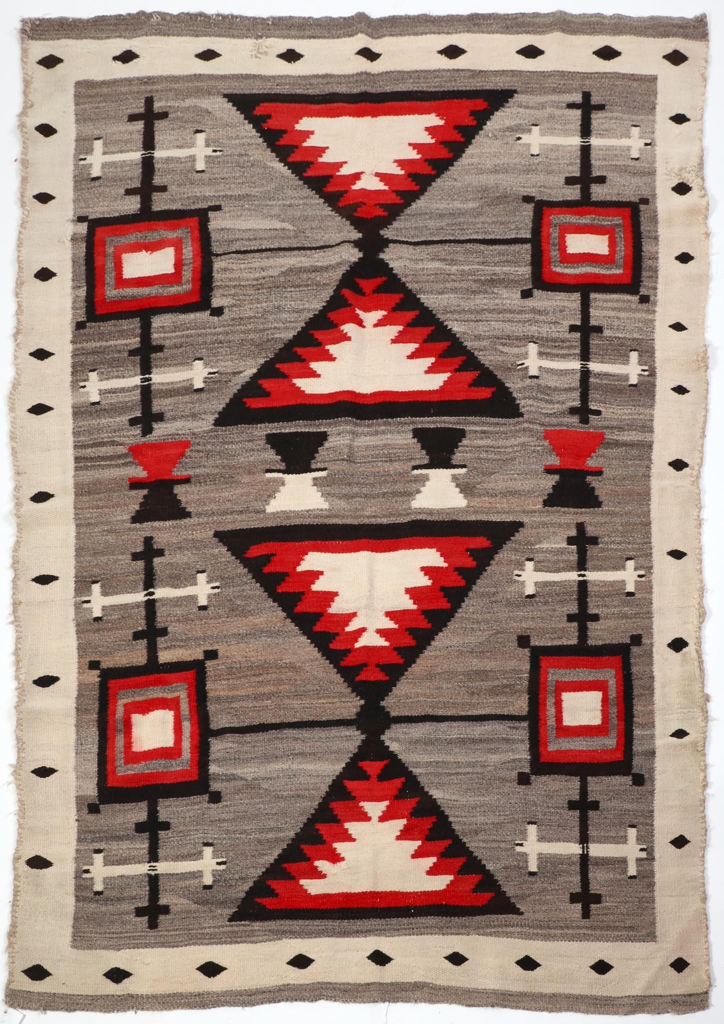 A NATIVE AMERICAN WOVEN RUG,