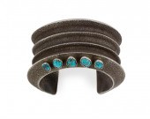 A NAVAJO TUFA-CAST SILVER BRAC