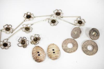 A necklace and ear clips of