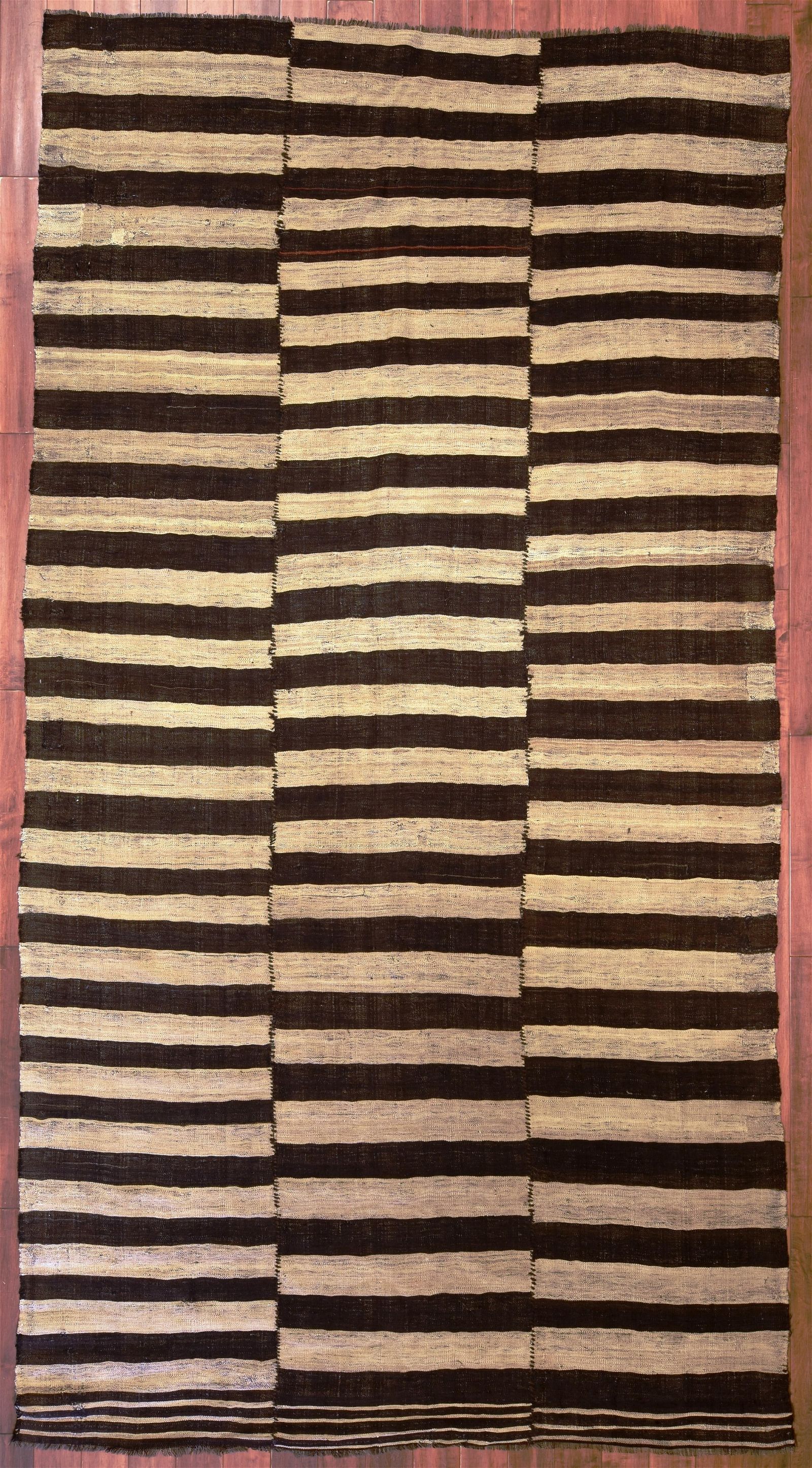 A NOMADIC FLATWEAVE CARPET,