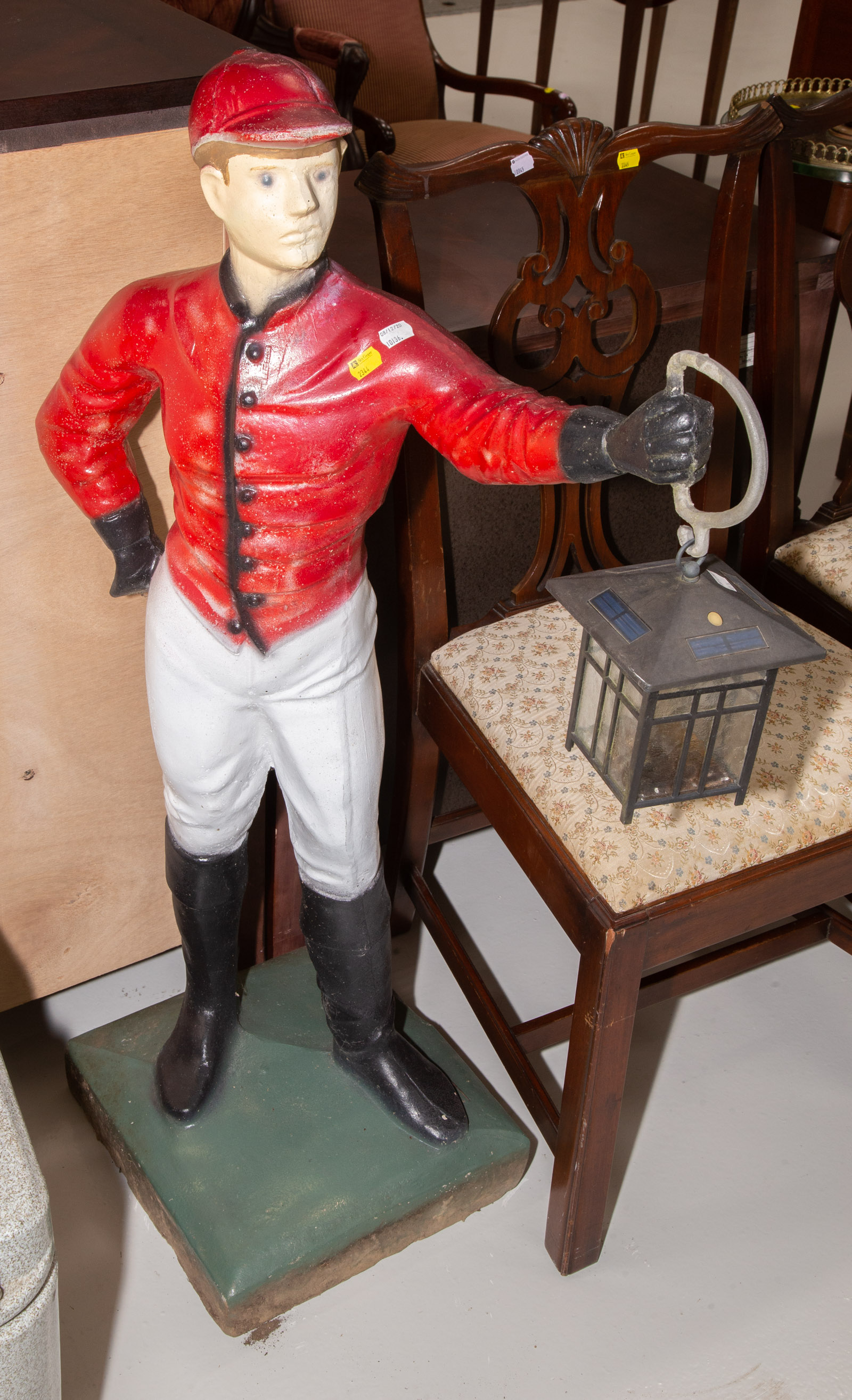 A PAINTED CAST IRON LAWN JOCKEY