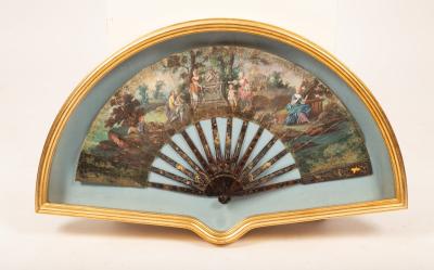 A painted fan decorated a bucolic
