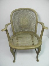 A painted wood and rattan armc