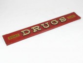 A painted wood drugstore sign