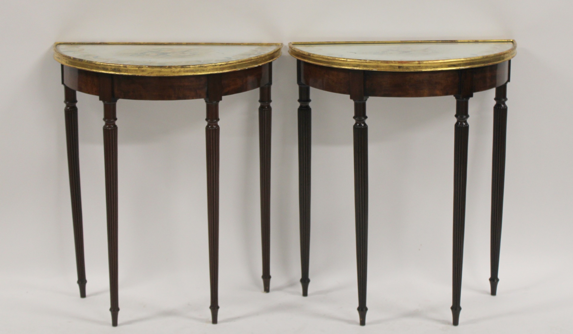 A PAIR OF ANTIQUE MAHOGANY DEMILUNE