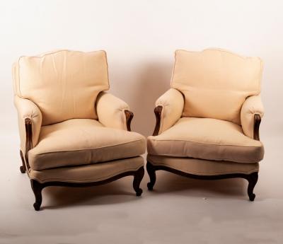A pair of beech framed armchairs on