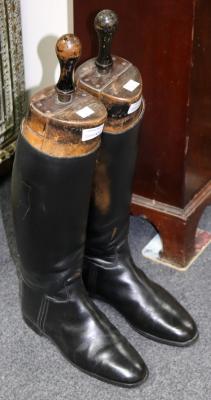 A pair of black leather riding
