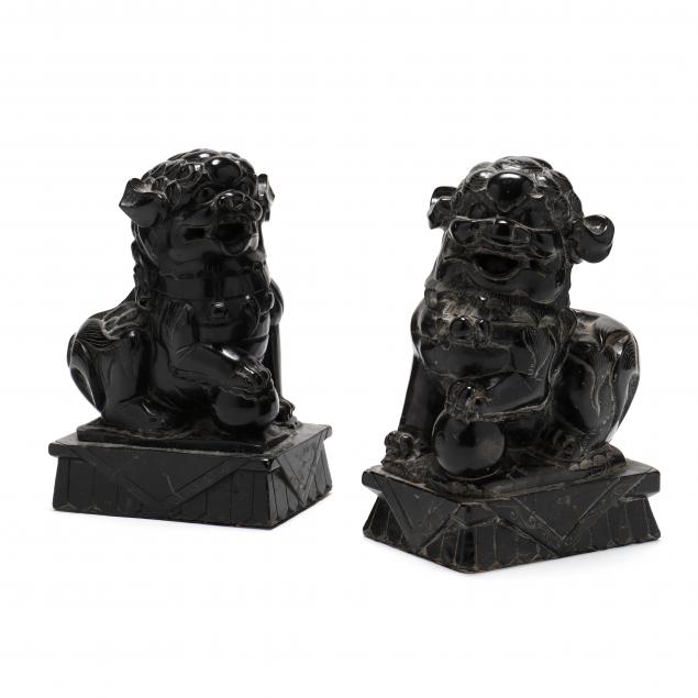 A PAIR OF BLACK MARBLE ASIAN FOO