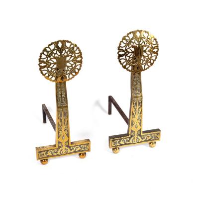A pair of brass fire dogs, the