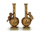 A PAIR OF BRONZE PUTTI VASES,