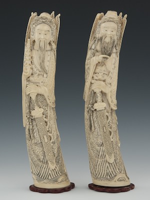 A Pair of Carved Ivory Figures A