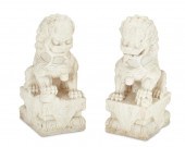 A PAIR OF CARVED MARBLE GUARDI