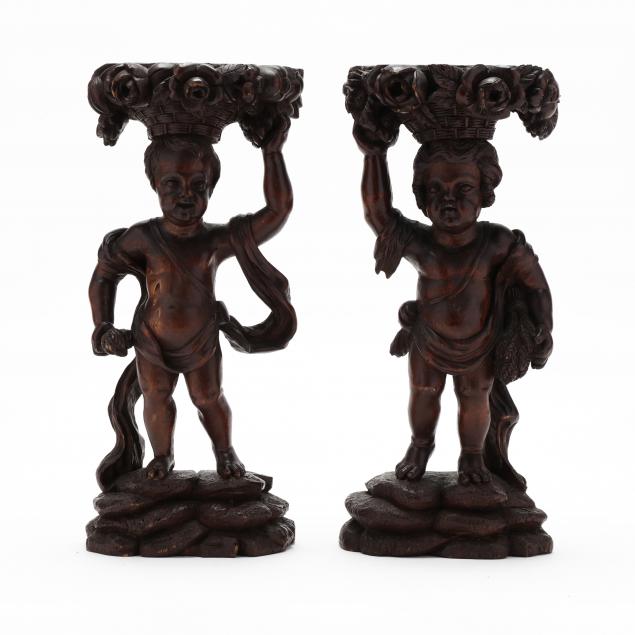 A PAIR OF CARVED WOOD STANDS IN THE