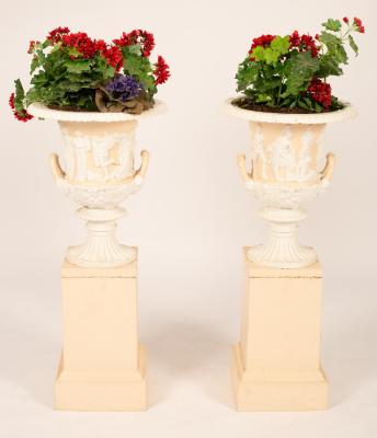 A pair of cast iron urns on
