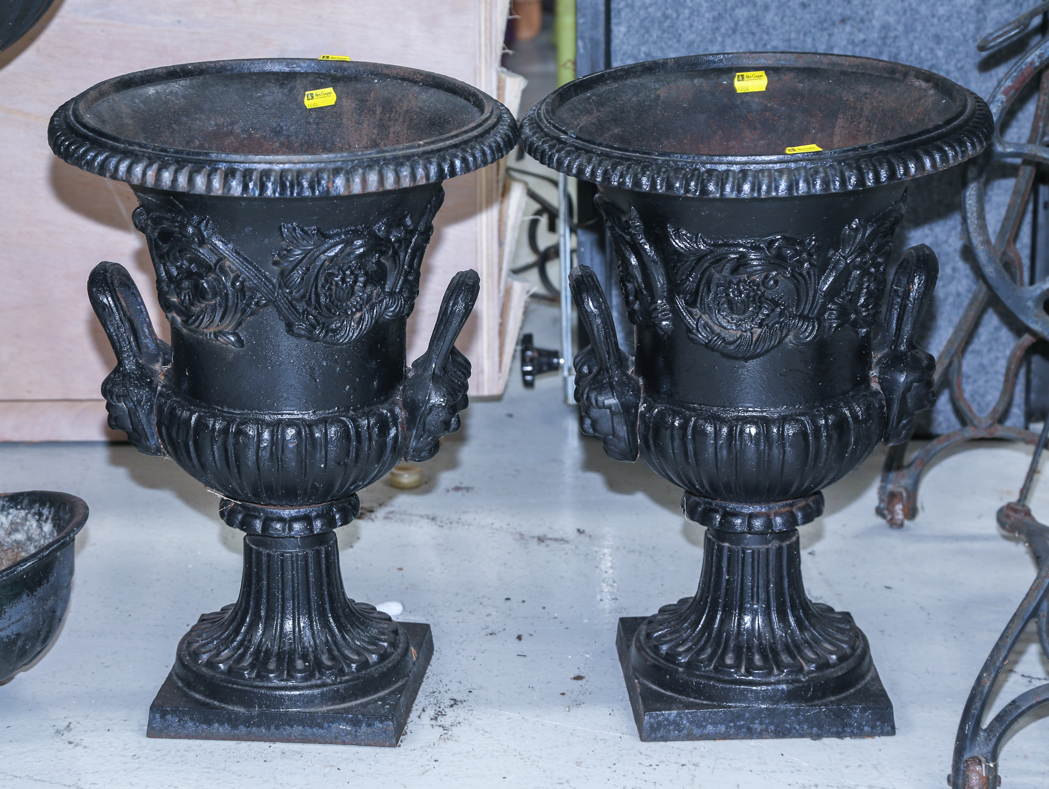 A PAIR OF CAST IRON GARDEN URNS