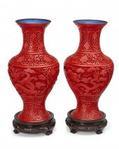 A PAIR OF CHINESE CINNABAR-STY