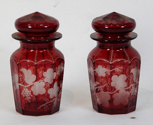 A pair of cranberry glass jars