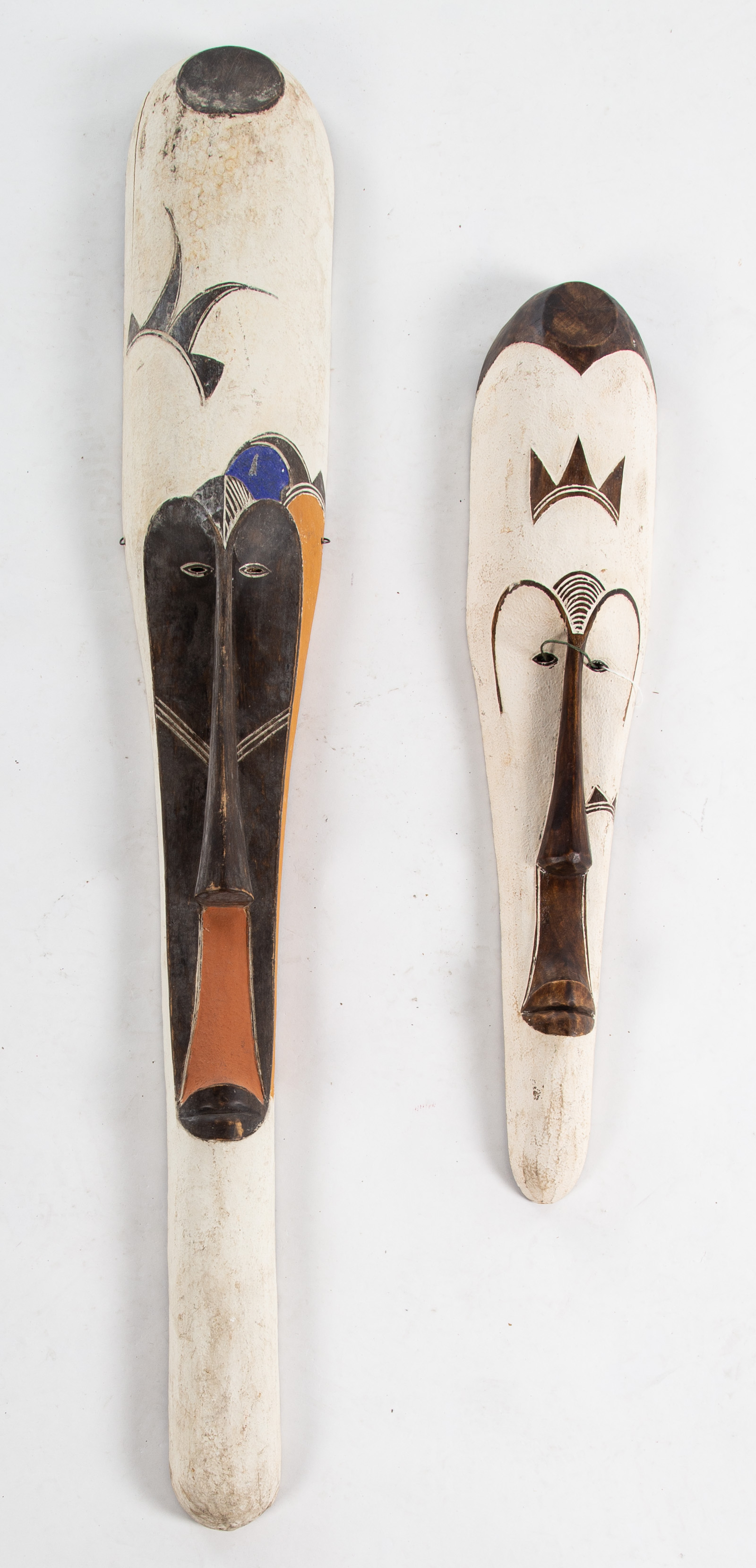 A PAIR OF DECORATIVE MASKS Carved