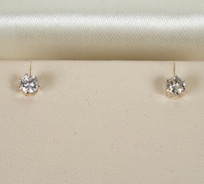 A pair of diamond ear studs, each