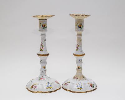 A pair of enamel candlesticks,