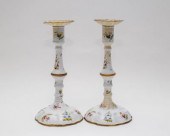A pair of enamel candlesticks,