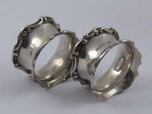A pair of fancy silver napkin rings