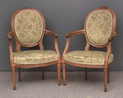 A pair of French walnut framed oval