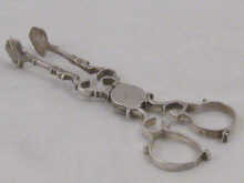 A pair of Georgian silver sugar