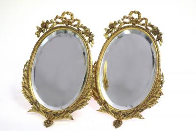 A pair of gilt metal framed oval
