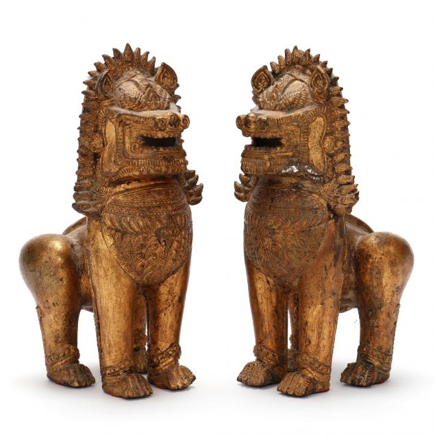 A PAIR OF GILT METAL TIBETAN LIONS