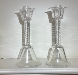 A pair of glass candlesticks with