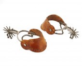 A PAIR OF HAND-TOOLED SPURS, B