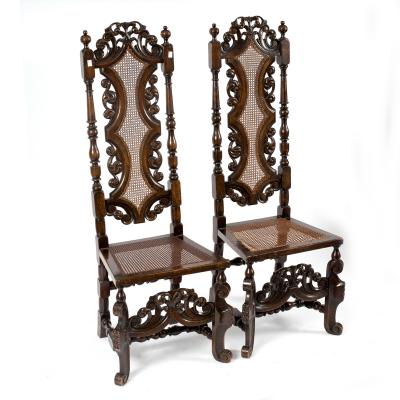 A pair of high back chairs of