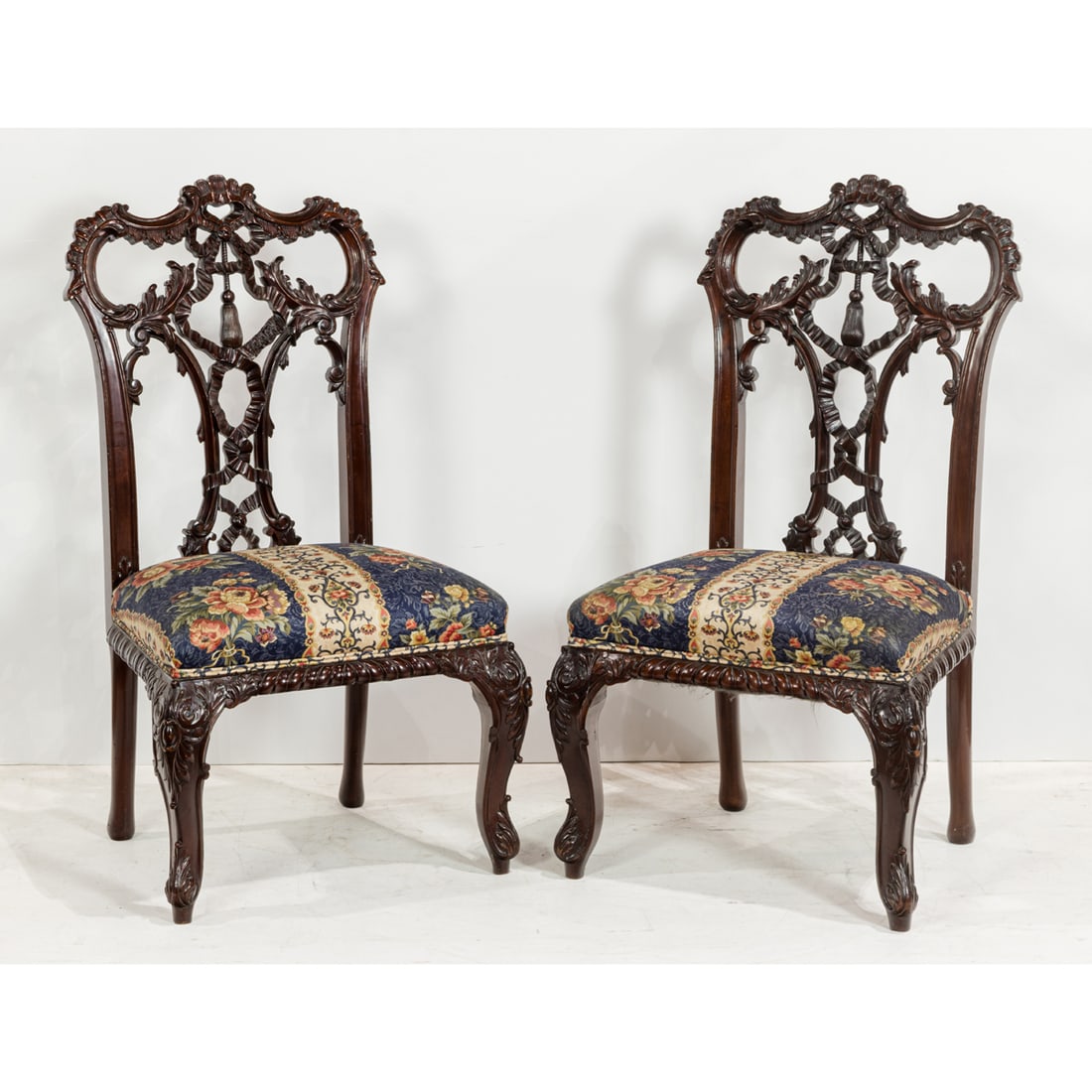 A PAIR OF HIGHLY CARVED MAHOGANY