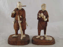 A pair of ivory and wood carved